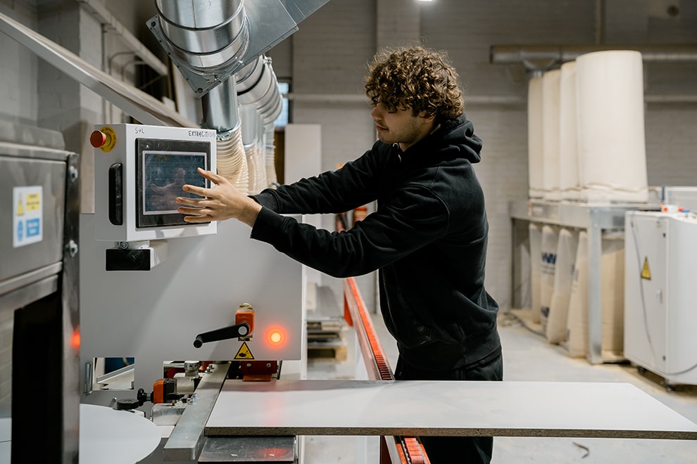 Guy using state-of-the-art machine manufacturing fitted furniture
