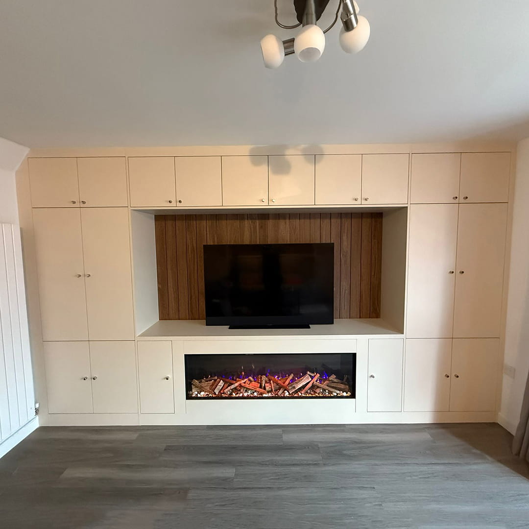Cream fitted media wall with TV, wood panel and electric fireplace