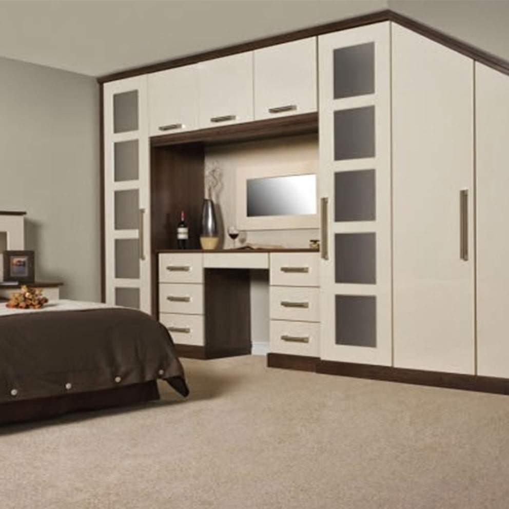 Cream and walnut corner wardrobes with a central dressing table