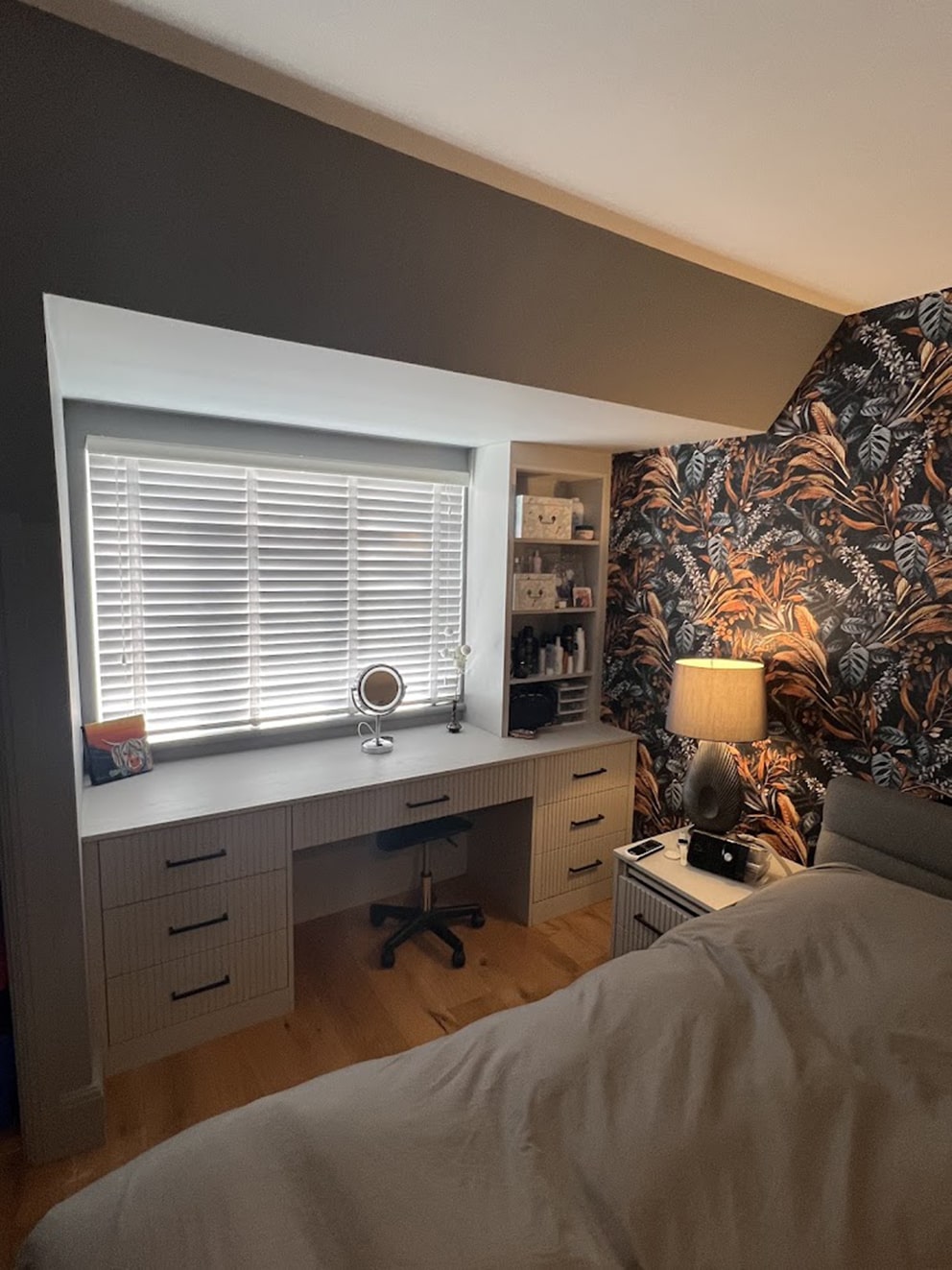 Fitted vanity desk with drawers under bedroom window