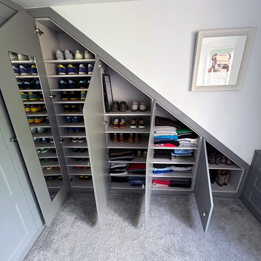 Grey under-eaves wardrobe with pull-out shoe and clothes storage