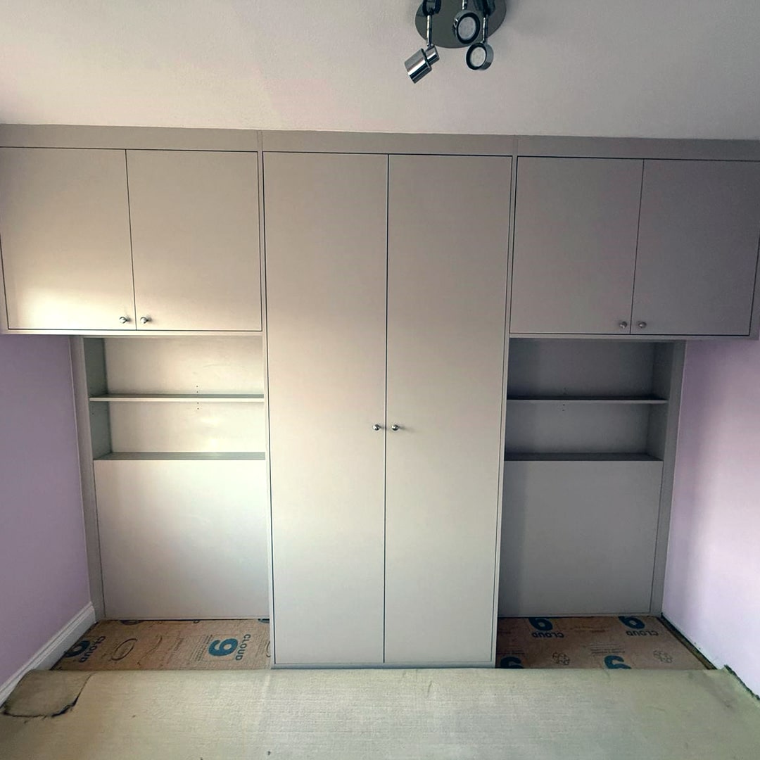 Grey overbed wardrobes with central unit and side shelves