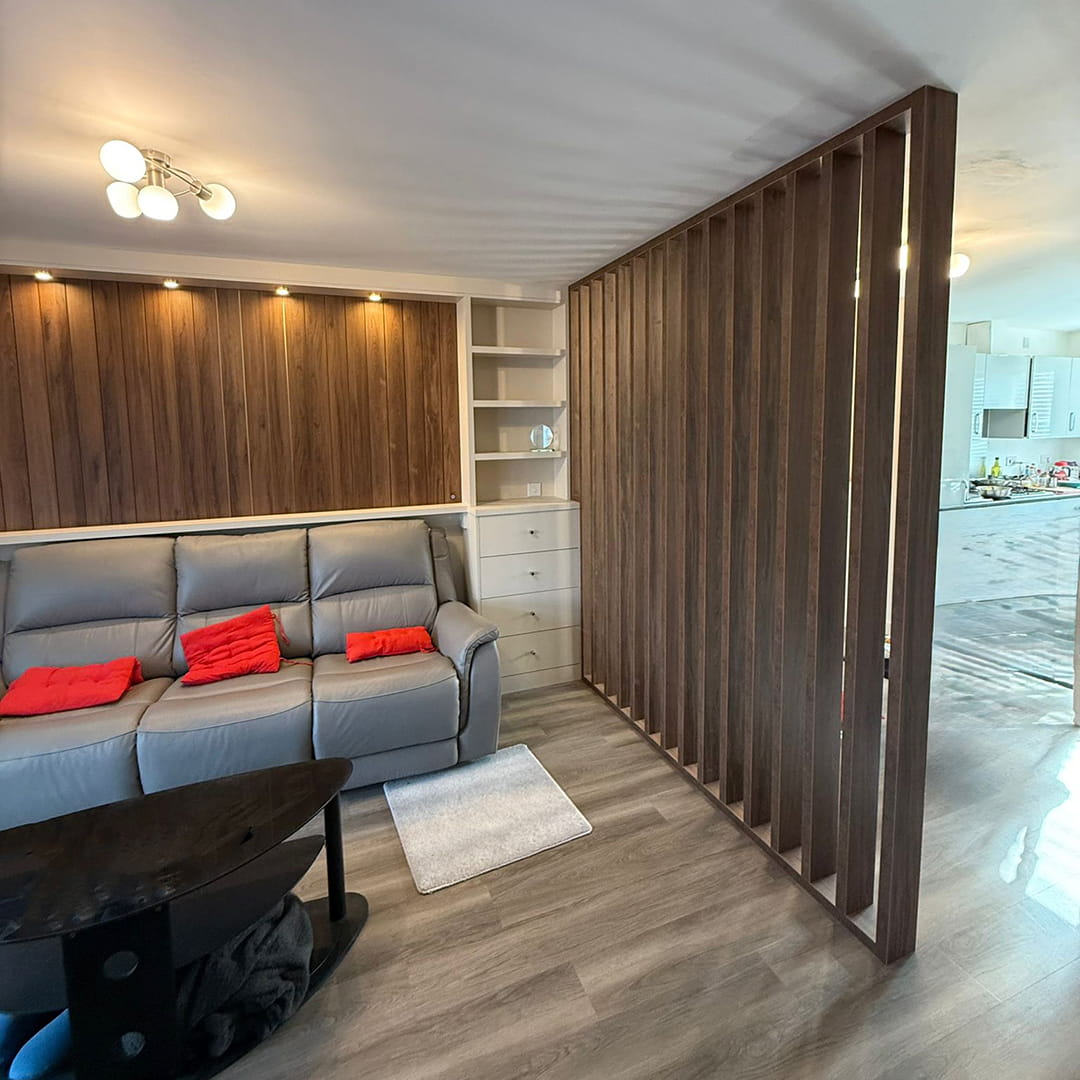 Walnut slatted room divider with media unit, drawers and grey sofa