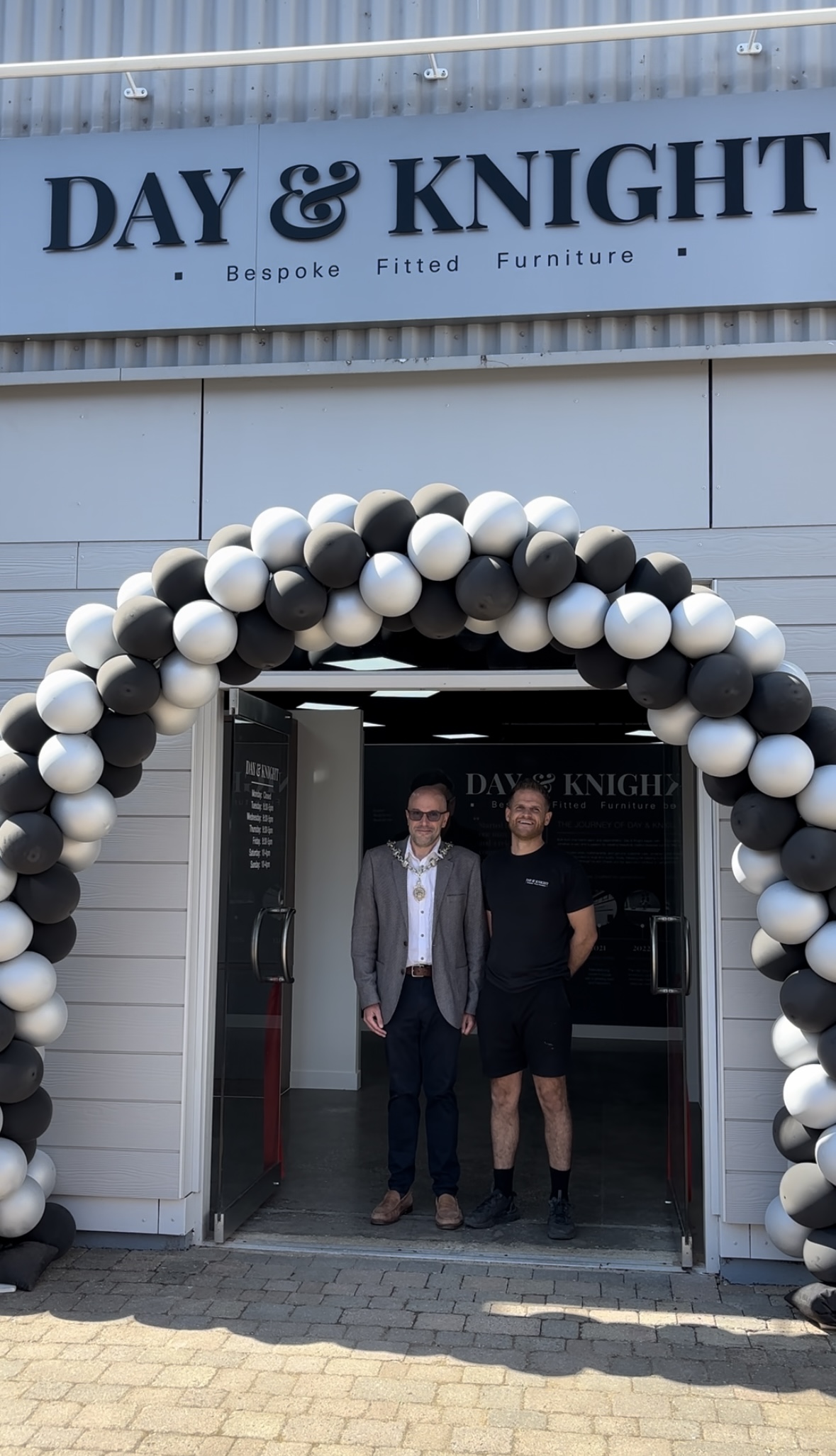 The Mayor of Wilton and a member of the DAY & KNIGHT team beneath the balloon arch at the Wilton showroom entrance on opening day